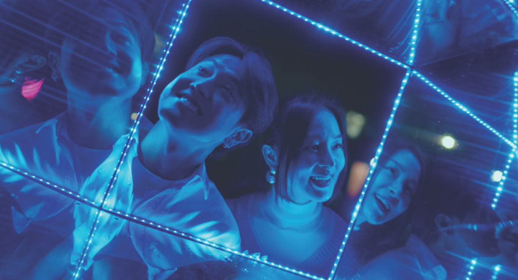 Group under blue neon light installation